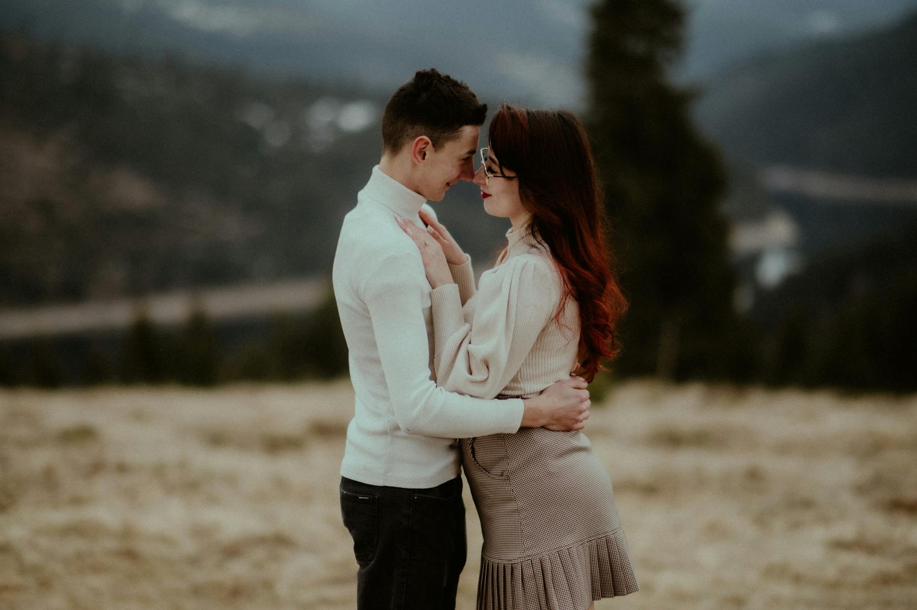 Zakochana para obejmuje się jesienią w górskim krajobrazie